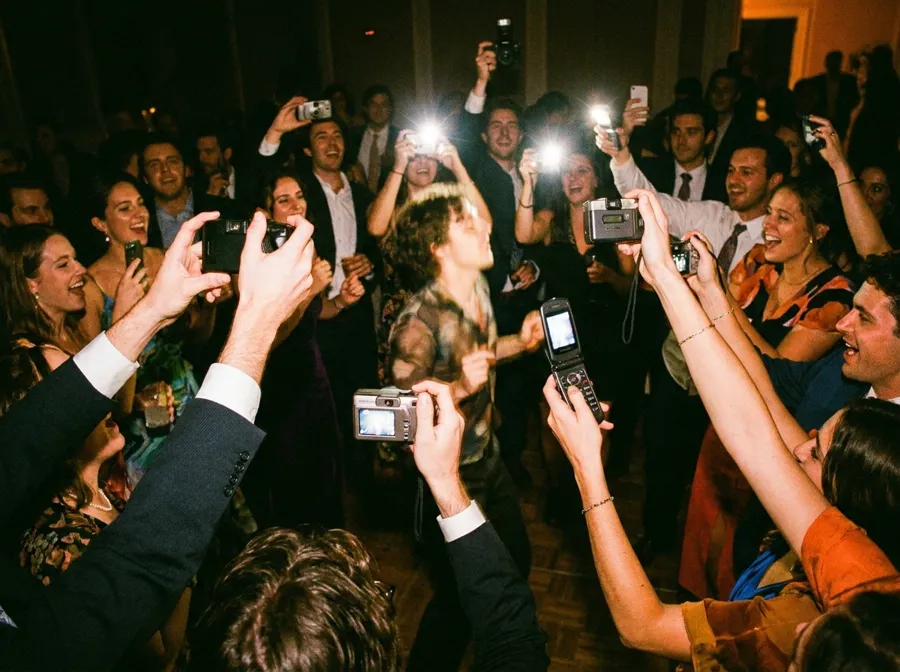 Guests raising phones and cameras on the dance floor